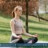 Woman meditating in nature, combining breathing exercises with physical activity for anxiety relief