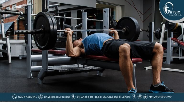 Man performing bench press with barbell in a gym, targeting chest muscles for strength and growth