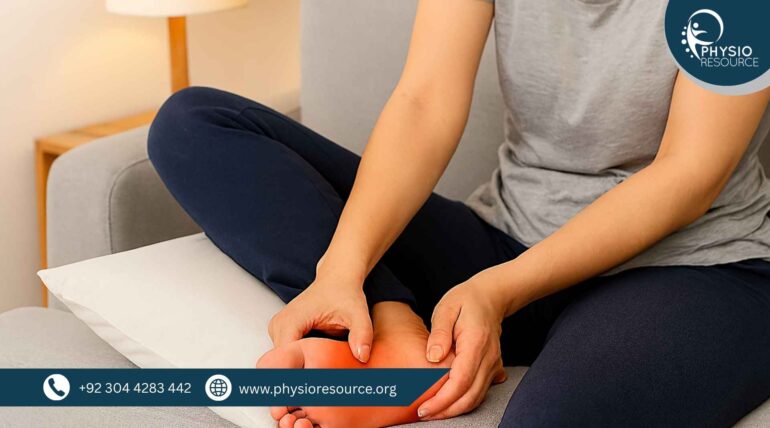 “Woman seated on a sofa with her swollen foot elevated on a pillow, gently pressing the inflamed area in a softly lit room.”