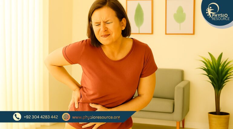 Middle-aged woman pressing her hip and abdomen in visible discomfort, standing in a bright, wellness-themed room with indoor plants and soft decor.
