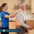 Woman experiencing lower back pain while standing and bending during Iftar food preparation in kitchen