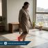 Walking barefoot at home on hard floors causing heel pain, highlighting plantar stress and need for physiotherapy treatment at Physio Resource Lahore