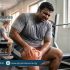 Person experiencing muscle or joint pain during intense gym workout in summer heat due to overtraining, highlighting physiotherapy care at Physio Resource Lahore